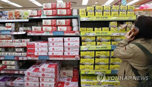 Un client prend un paquet de riz cuit prêt-à-consommer dans un supermarché de Séoul, le 21 mars 2020.