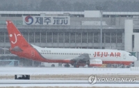 눈 내리는 제주공항(제주=연합뉴스) 박지호 기자 = 제주도에 대설특보가 내려진 24일 오전 제주국제공항 활주로에서 한 항공기가 이륙을 준비하고 있다. 2018.1.24jihopark@yna.co.kr(끝) 