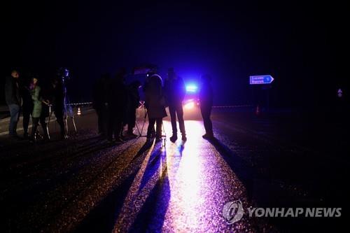 Reporters near the scene of the bus accident