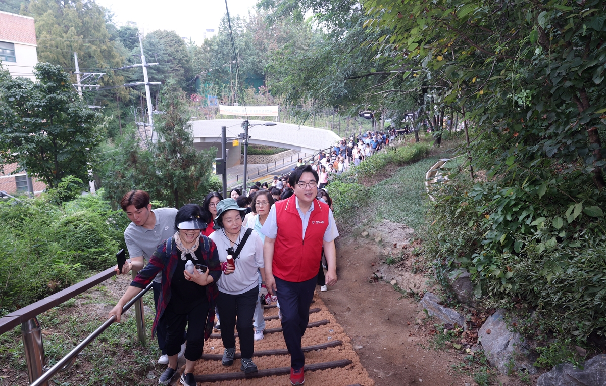 국사봉 생태육교 준공식을 마치고 인근 둘레길을 걷는 박일하 구청장(앞줄 오른쪽)