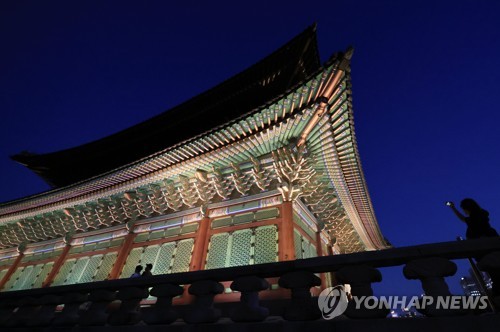 Unos visitantes recorren el palacio Gyeongbok, en el centro de Seúl, el 1 de septiembre de 2022, después de que el palacio real comenzara su programa de recorridos nocturnos, que se llevará a cabo hasta el 6 de noviembre.