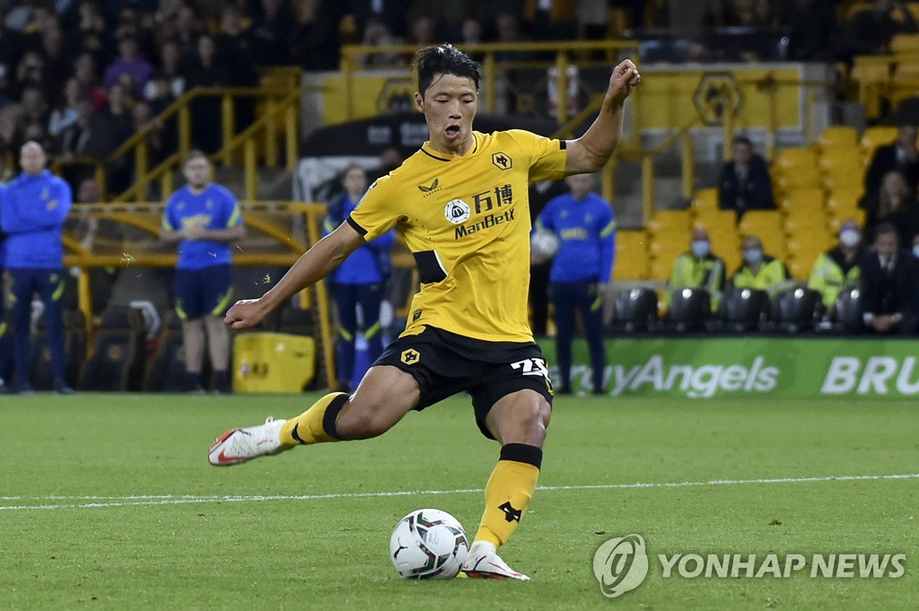 In this Associated Press photo, Hwang Hee-chan of Wolverhampton Wanderers takes a kick during the penalty shootout against Tottenham Hotspur in the third round of the Carabao Cup at Molineux Stadium in Wolverhampton, England, on Sept. 22, 2021. (Yonhap)
