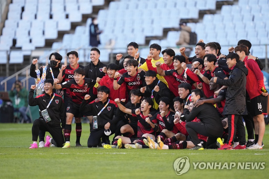 In this Associated Press photo, players and coaches of Pohang Steelers celebrate their 3-0 victory over Nagoya Grampus in the quarterfinals of the Asian Football Confederation Champions League at Jeonju World Cup Stadium in Jeonju, 240 kilometers south of Seoul, on Oct. 17, 2021. (Yonhap)