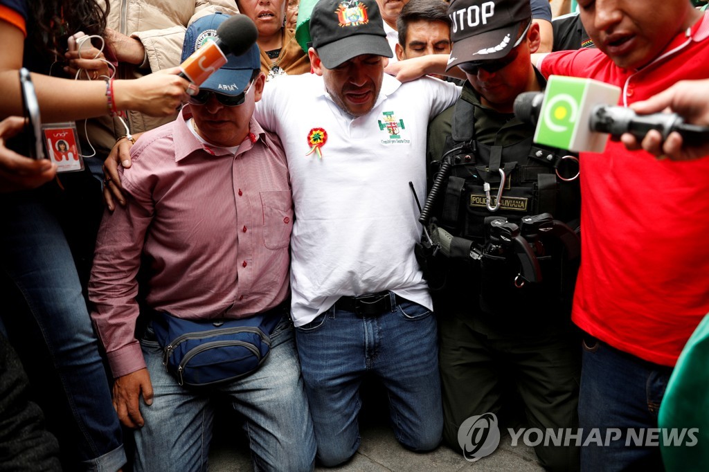 모랄레스 퇴진 시위를 주도한 야권 지도자 카마초가 시위 도중 기도하고 있다.
