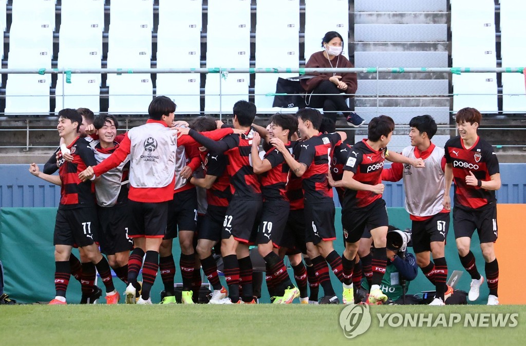 In this Reuters photo, Pohang Steelers players celebrate their goal against Nagoya Grampus during the clubs' quarterfinal match of the Asian Football Confederation Champions League at Jeonju World Cup Stadium in Jeonju, 240 kilometers south of Seoul, on Oct. 17, 2021. (Yonhap)