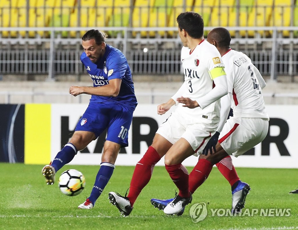 South Korea's FC Seoul striker Dejan Damjanovic, left, fights for