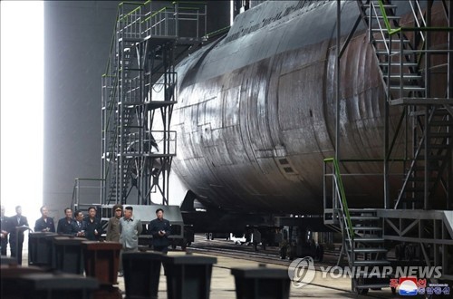 This photo, released by the Korean Central News Agency on July 23, 2019, shows North Korean leader Kim Jong-un (2nd from R) inspecting a newly built submarine. As is customary, the agency didn't provide the date and location. (For Use Only in the Republic of Korea. No Redistribution) (Yonhap)