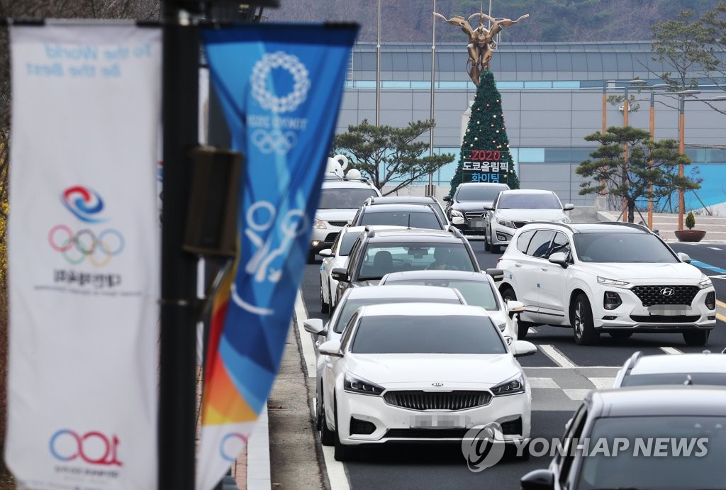 In this file photo from March 27, 2020, vehicles are lined up near the exit of the Jincheon National Training Center in Jincheon, 90 kilometers south of Seoul, as athletes and coaches move out of the facility following the postponement of the Tokyo Olympics. (Yonhap)