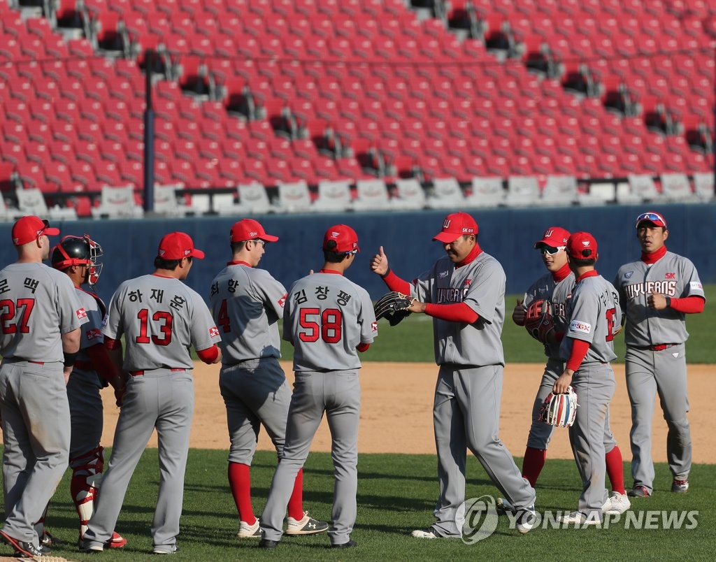 In this file photo from April, 24, 2020, members of the SK Wyverns celebrate their 4-3 victory over the LG Twins in a Korea Baseball Organization preseason game at Jamsil Stadium in Seoul. (Yonhap)