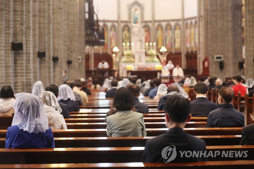 Catholics attend Mass while maintaining social distancing at Myeongdong Cathedral in Seoul on April 23, 2020.