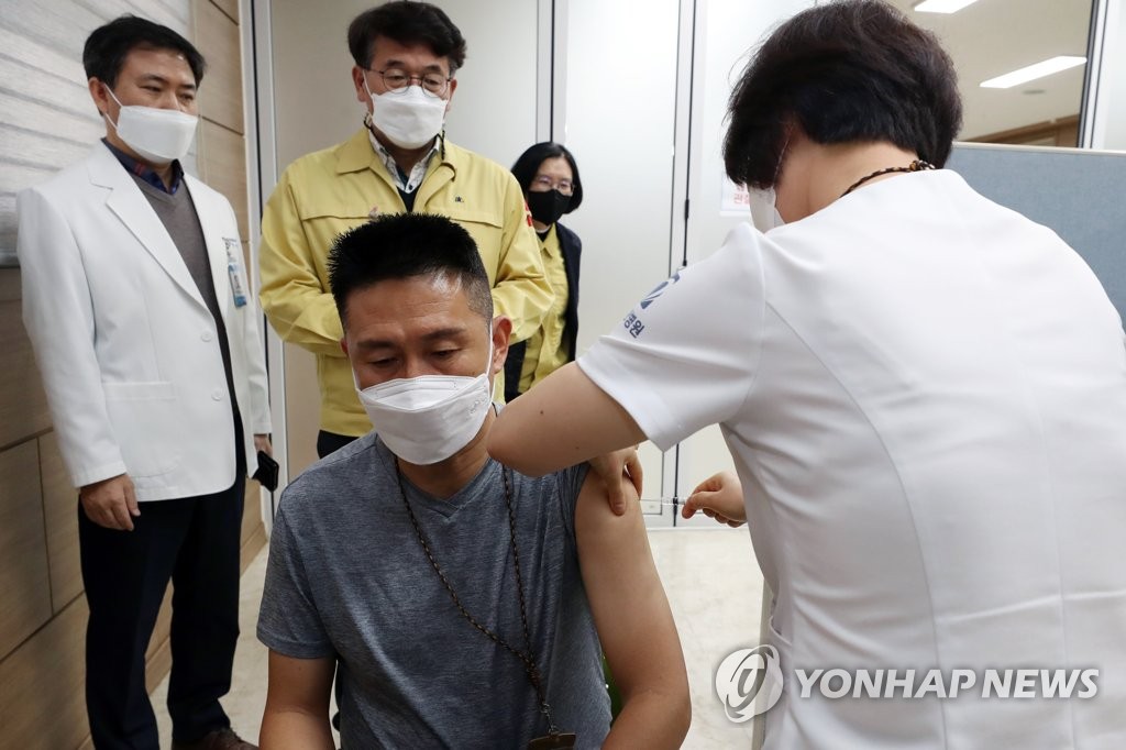 A health care worker from a nursing facility receives AstraZeneca's COVID-19 vaccine at a hospital in Gwangju, 330 kilometers south of Seoul, on Feb. 27, 2021. (Yonhap)