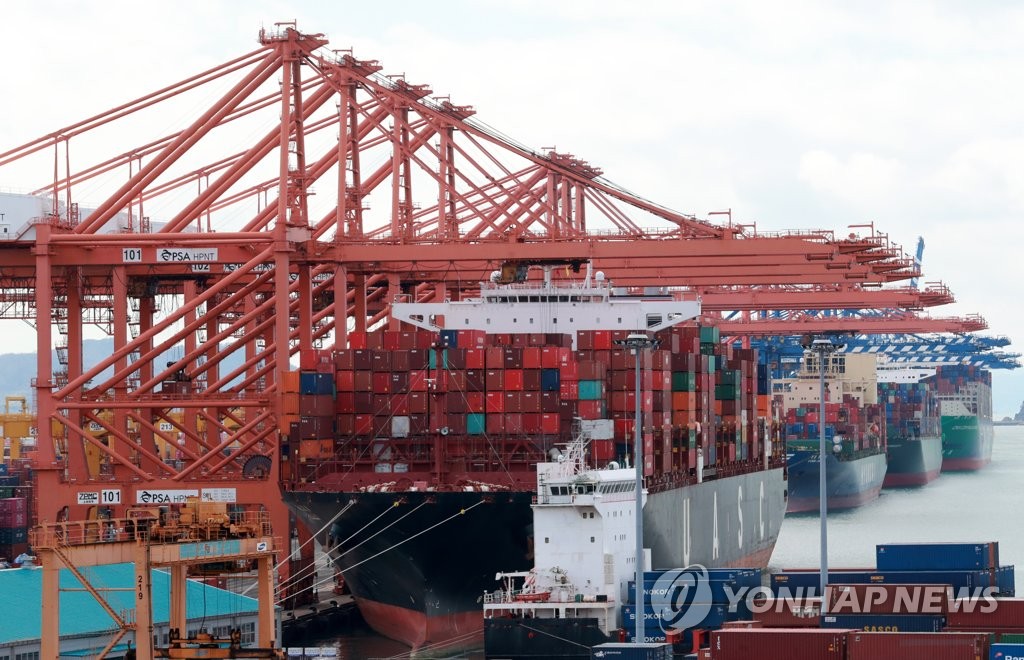 Cargo containers are stacked at a port in Busan, 453 kilometers southeast of Seoul, on March 2, 2021. (Yonhap)