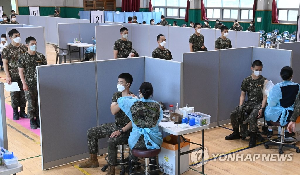 This photo taken on June 24, 2021, and provided by the National Assembly press corps, shows soldiers receiving coronavirus vaccines at a military unit in Goyang, Gyeonggi Province. (PHOTO NOT FOR SALE) (Yonhap)