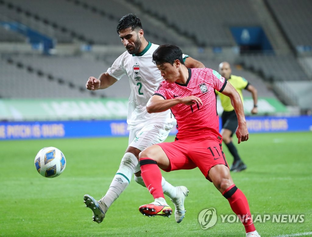 In this file photo, Hwang Hee-chan of South Korea (R) battles Ahmed Ibrahim of Iraq for the ball during the teams' Group A match in the final Asian qualifying round for the 2022 FIFA World Cup at Seoul World Cup Stadium in Seoul on Sept. 2, 2021. (Yonhap)