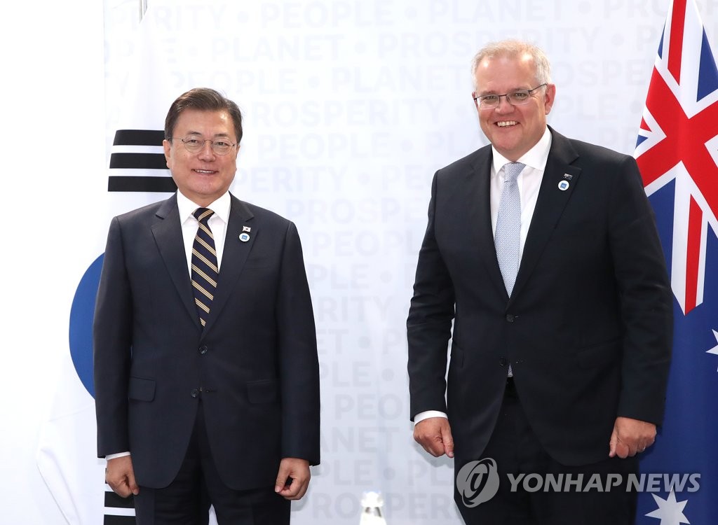 South Korean President Moon Jae-in (L) and Australian Prime Minister Scott Morrison pose for a camera before holding a bilateral summit in Rome, Italy, on Oct. 31, 2021. (Yonhap) 