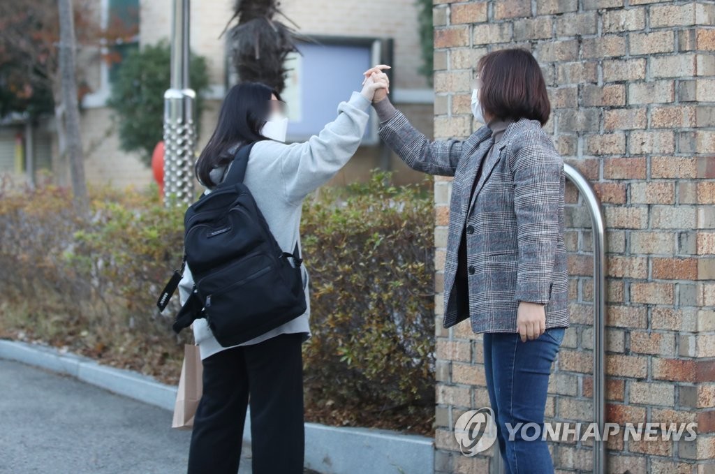 '긴장하지 말고 파이팅'  (광주=연합뉴스) 천정인 기자 = 대학수학능력시험이 치러지는 18일 오전 광주 서구 광주여고 앞에서 학부모가 수험생을 응원하고 있다. 2021.11.18 iny@yna.co.kr