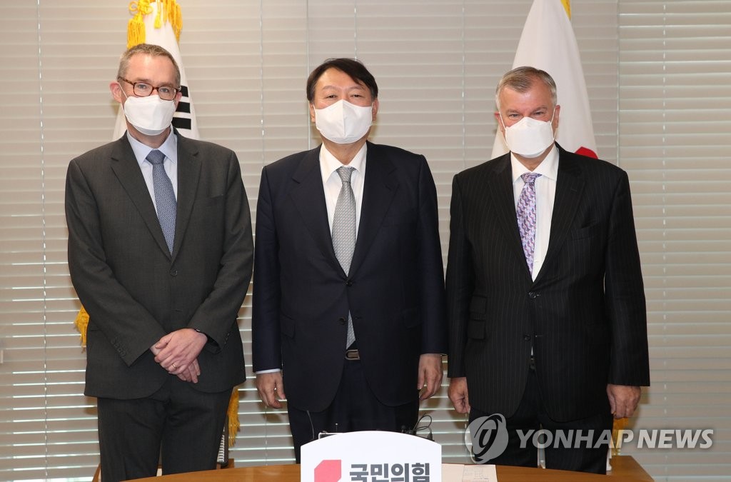 Yoon Seok-youl (C), the presidential nominee of the main opposition People Power Party, poses with British Ambassador to South Korea Simon Smith (R) and British Ambassador to North Korea Colin Crooks at the party's headquarters in Seoul on Dec. 2, 2021. (Pool photo) (Yonhap)