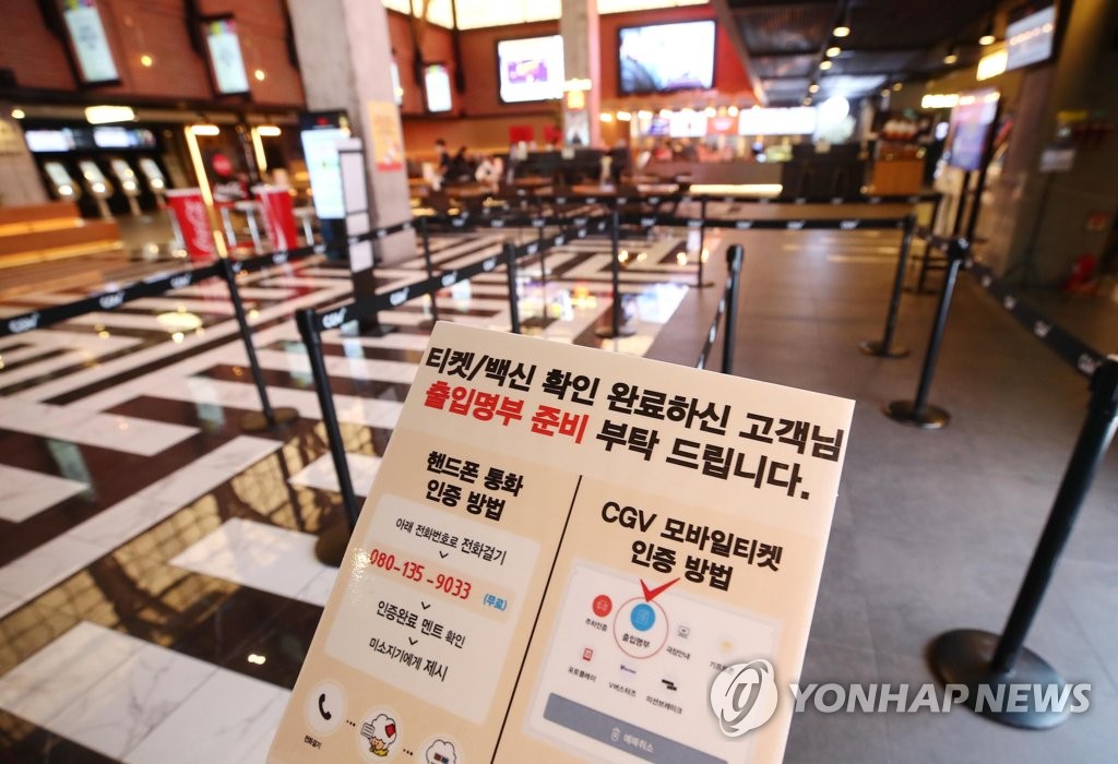 In this file photo taken Dec. 5, 2021, a sign at a Seoul movie theater asks people for their identity verification. (Yonhap)
