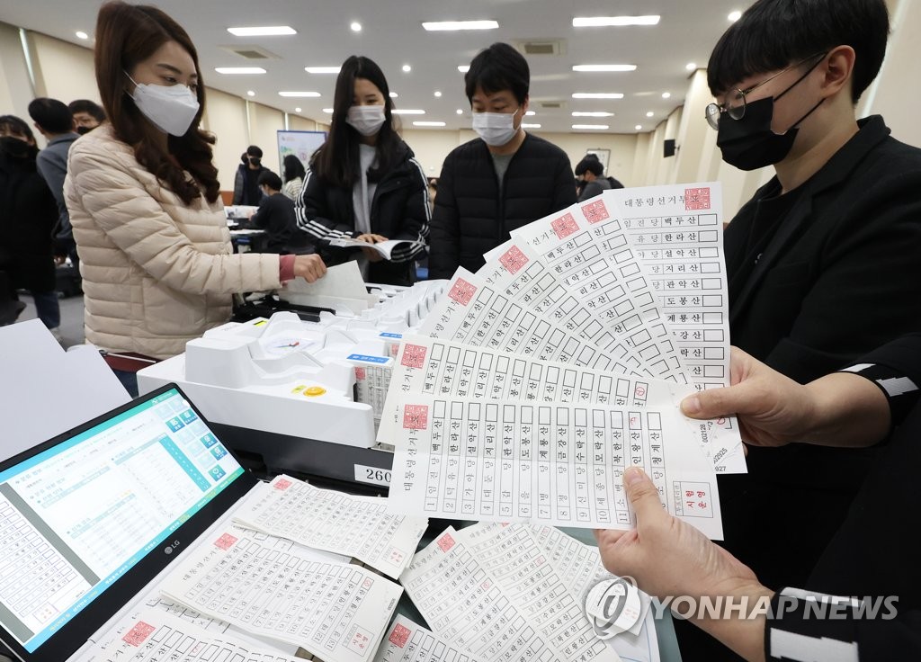 Public officials at an election management committee in Suwon, south of Seoul, receive instructions on paper ballots and voting machines ahead of the March 9 presidential election, in this photo taken on Jan. 26, 2022. (Yonhap)