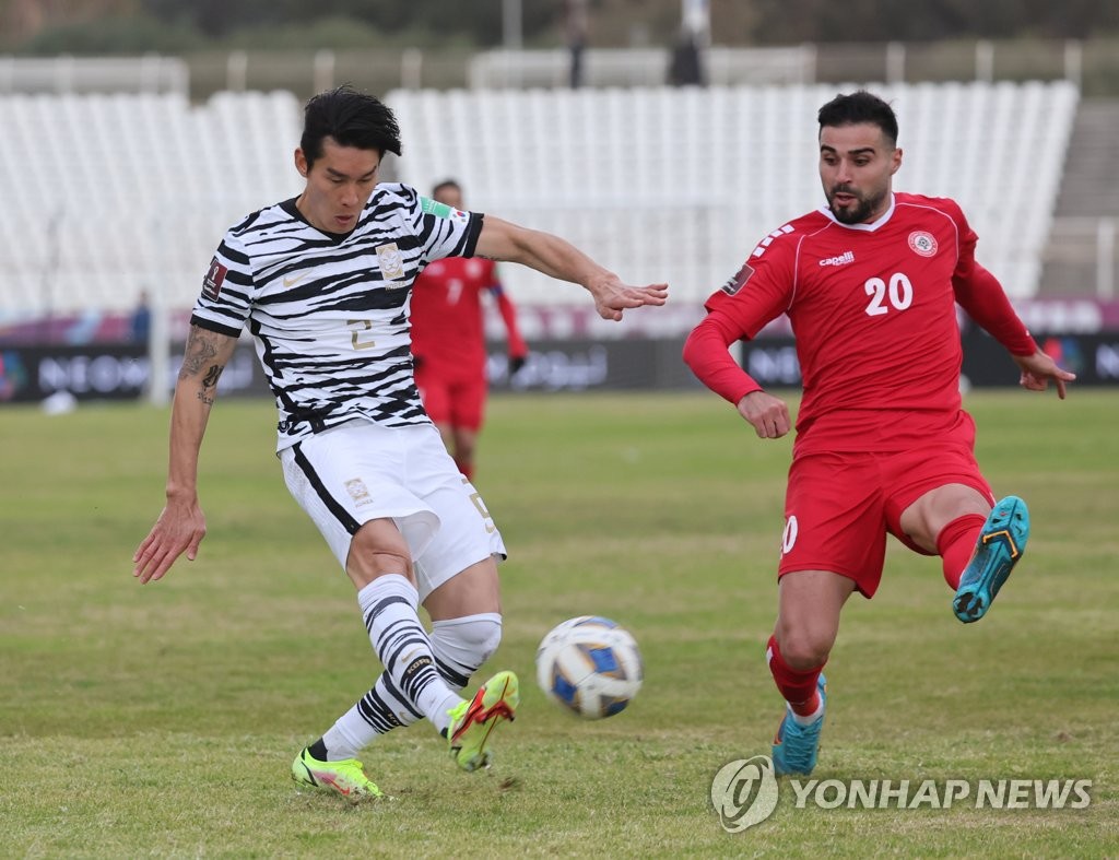 Lee Yong of South Korea (L) attempts a pass past Soony Saad of Lebanon during the teams' Group A match in the final Asian qualifying round for the 2022 FIFA World Cup at Saida International Stadium in Sidon, Lebanon, on Jan. 27, 2022. (Yonhap)