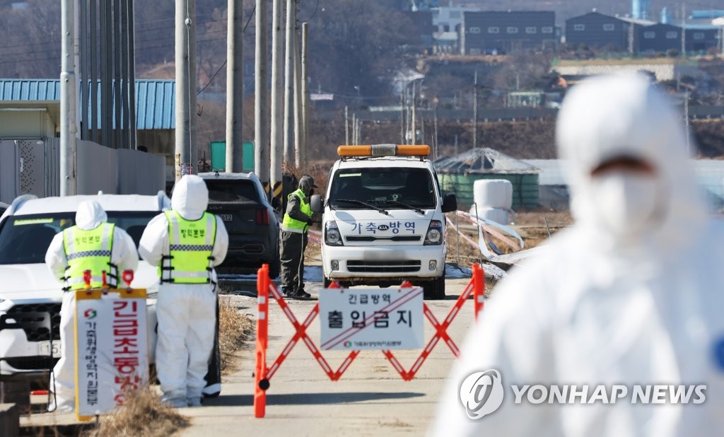 In this file photo, disinfection operations are under way near a chicken farm in Pyeongtaek, 70 kilometers south of Seoul, on Feb. 8, 2022, after a suspected case of highly pathogenic avian influenza was reported there. (Yonhap)