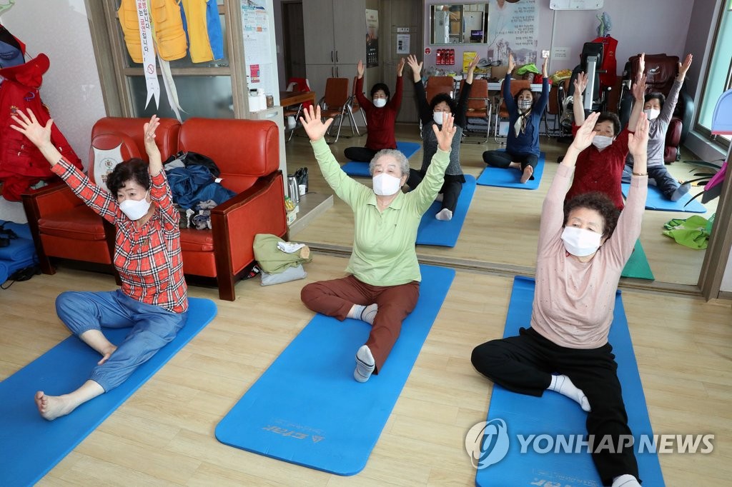 In this photo taken on May 2, 2022, and provided by Inje County, elderly women join a group exercise program at a senior citizen center in Inje, Gangwon Province, amid eased virus curbs. (Yonhap)