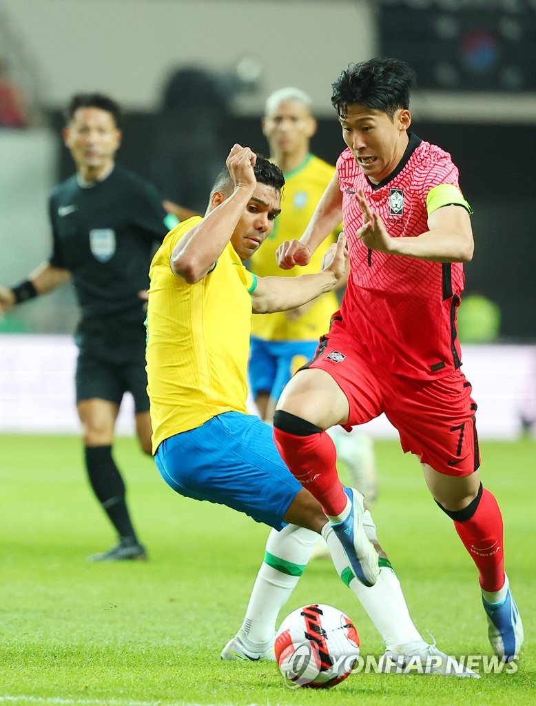 In this file photo from June 2, 2022, Son Heung-min of South Korea (R) tries to dribble past Casemiro of Brazil during the countries' friendly football match at Seoul World Cup Stadium in Seoul. (Yonhap)