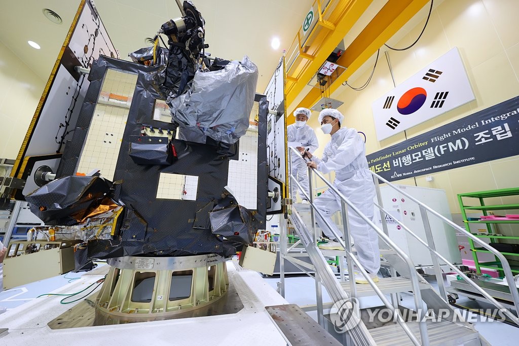 This photo provided by the Korea Aerospace Research Institute in Daejeon on June 6, 2022, shows aerospace engineers inspecting Danuri, South Korea's first lunar orbiter scheduled to be launched into space in early August from Cape Canaveral Space Force Station in Florida. (PHOTO NOT FOR SALE) (Yonhap) 