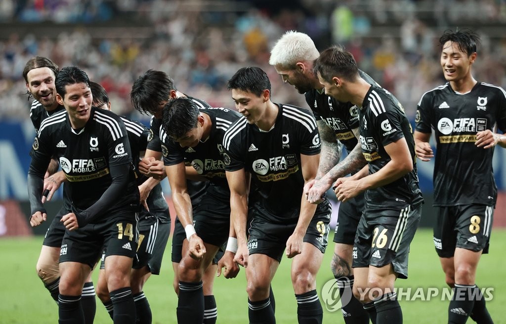 Team K League players celebrate a goal by Cho Gue-sung (3rd from R) against Tottenham Hotspur during the teams' exhibition match at Seoul World Cup Stadium in Seoul on July 13, 2022. (Yonhap)