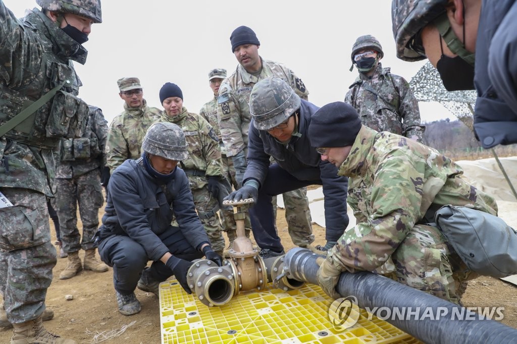 South Korean and U.S. logistics troops connect a pipe to install a fuel tank in the border county of Cheorwon, 71 kilometers northeast of Seoul, as part of five-day combined logistics support drills that began March 13, in this photo provided by the South's Army on March 17, 2023. (PHOTO NOT FOR SALE) (Yonhap)