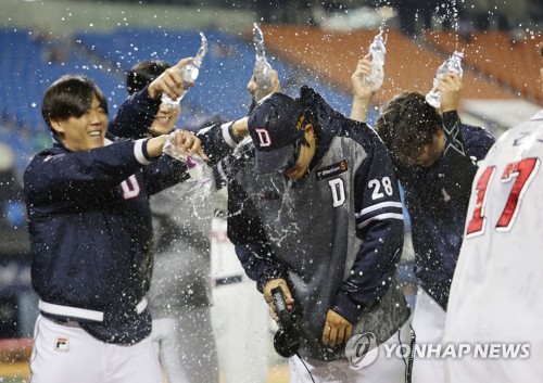 Doosan Bears starter Jang Won-jun (C) is doused with water after earning his 130th career victory in the Korea Baseball Organization in a 7-5 win over the Samsung Lions at Jamsil Baseball Stadium in Seoul on May 23, 2023. (Yonhap)