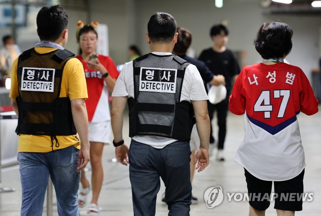 Police officers patrol a baseball stadium in the southwestern city of Gwangju in the wake of two stabbing rampages in Seoul and Gyeonggi Province on Aug. 8, 2023. (Yonhap)
