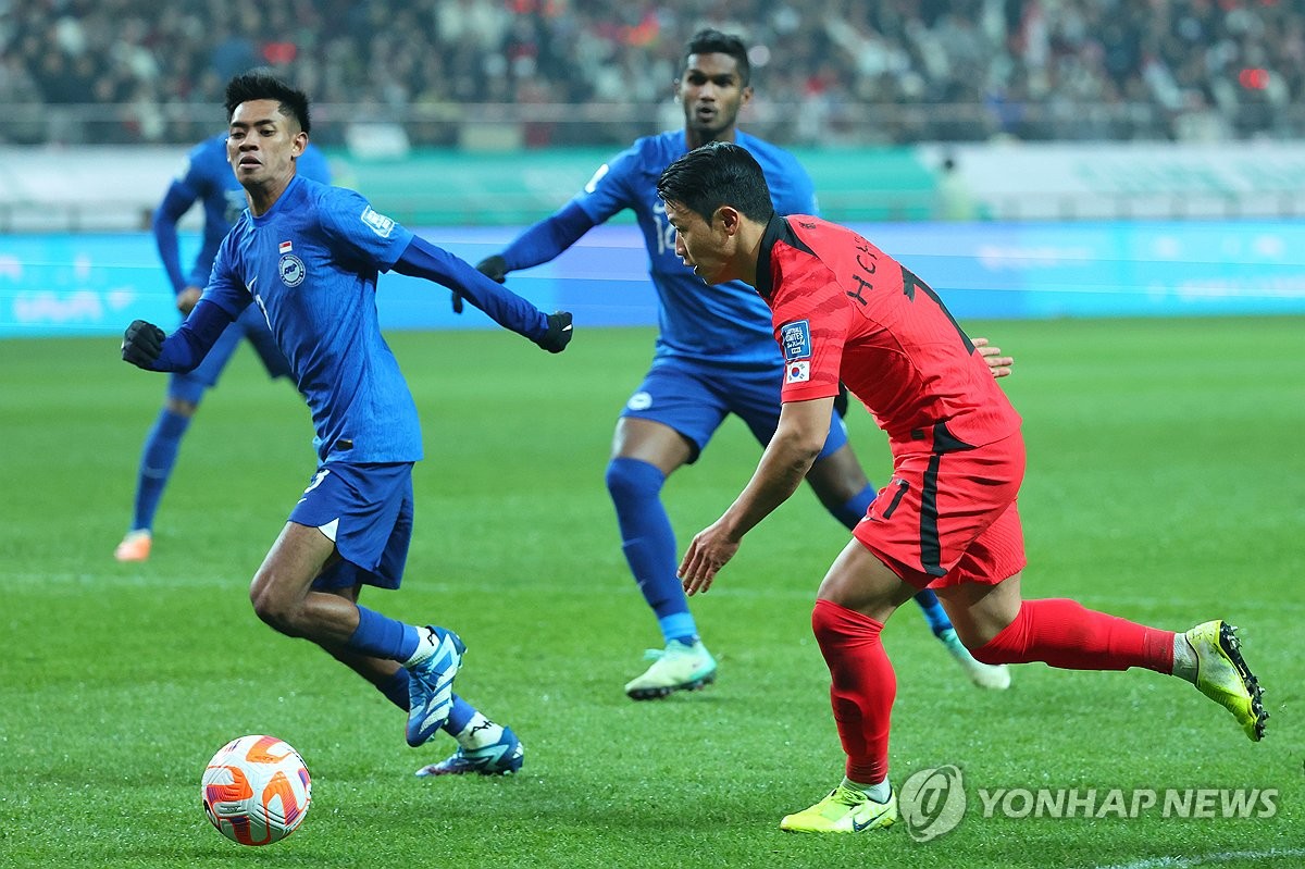 Hwang Hee-chan of South Korea (R) dribbles the ball against Singapore during the teams' Group C match in the second round of the Asian World Cup qualification tournament at Seoul World Cup Stadium in Seoul on Nov. 16, 2023. (Yonhap)