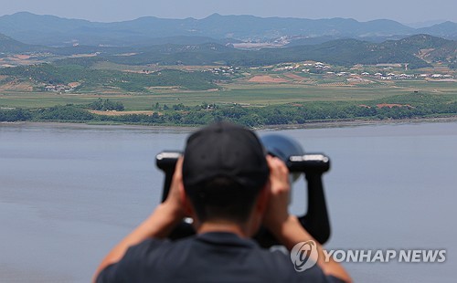 Tourist looks out at N. Korean border city